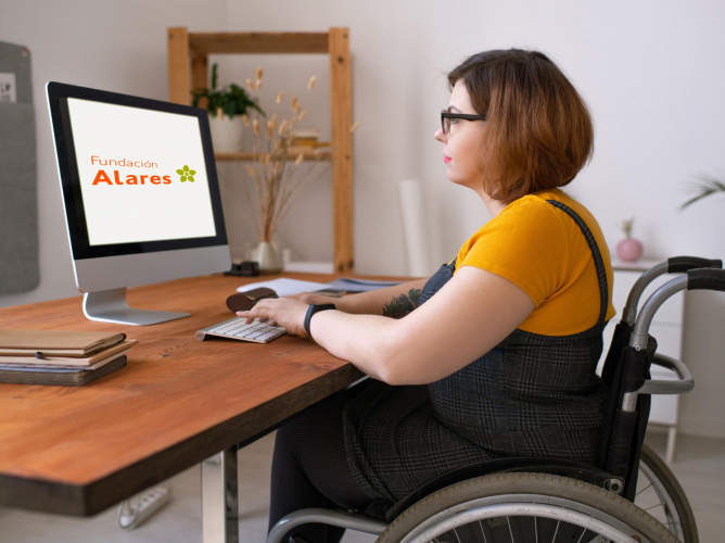 Serious young disabled woman in glasses sitting in wheelchair and entering login while preparing to start e-learning class at home